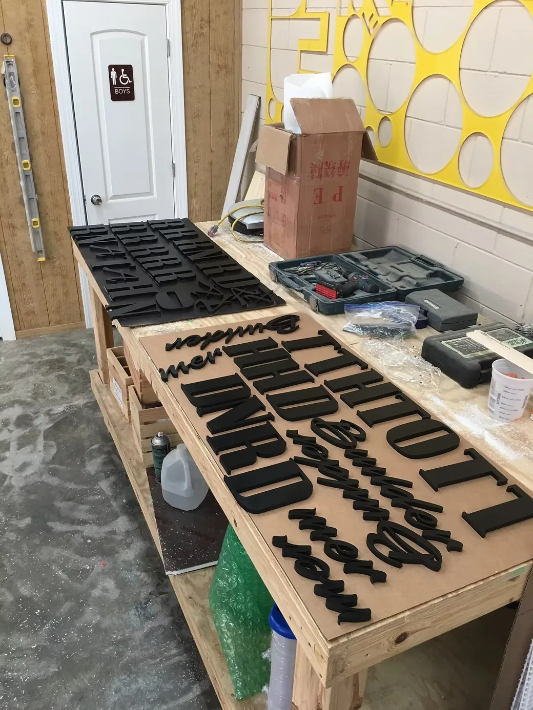Black Dimensional Letters On Production Table