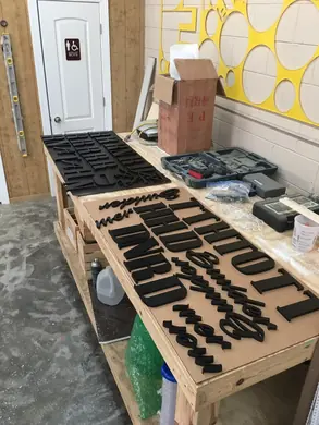 Black dimensional letters on the production table