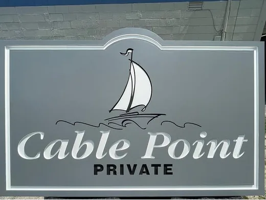 Cable Point Private gray and white community sign with sailboat graphic