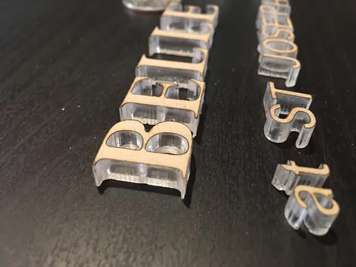 Flat-cut acrylic sign letters and layered components