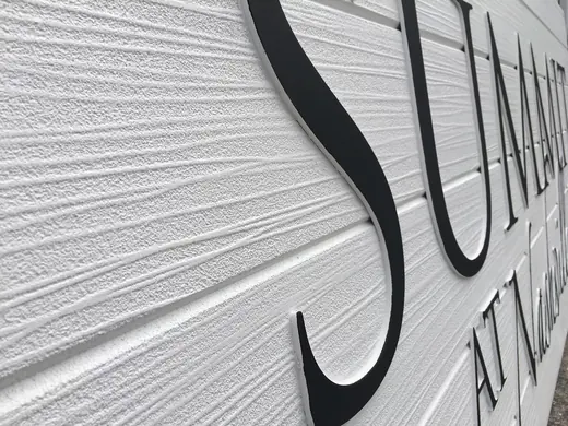 Dimensional channel letters on a textured wall