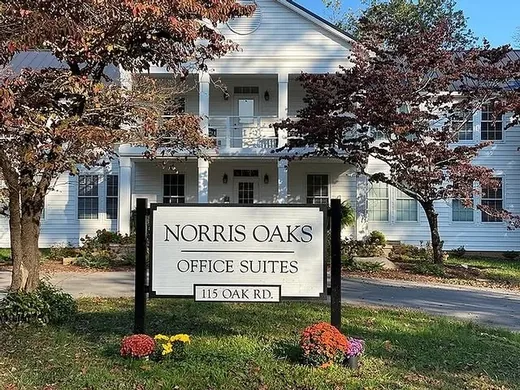 Norris Oaks office suites property sign installed in front of a white office building