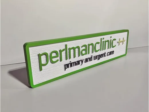 Perlman Clinic primary and urgent care dimensional desk sign with green border