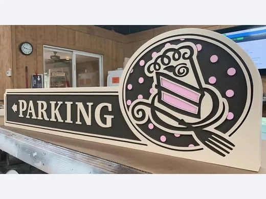 Piece A Cake parking directional sign with dimensional cupcake logo and arrow